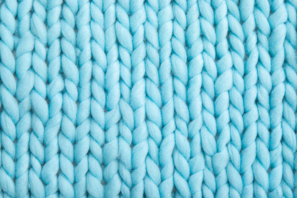 Close up above view of light blue soft wool knitted wool blanket background. stock photo