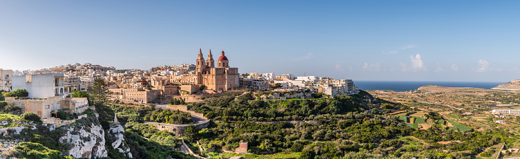Panoramic view of Il-Mellieha, Malta -  Mellieha town at sunny day with Paris Church on hill top, bay, sea and Gozo in background
