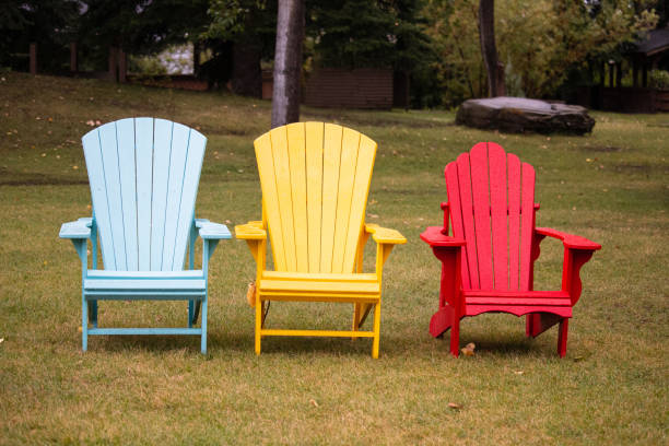 istock A single line of three Adirondack chairs in an empty outdoor green space 1445164054