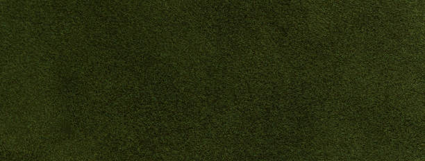 istock Texture of velvet matte dark green background, macro. Suede olive fabric with pattern. Textile leather backdrop, 1445168689