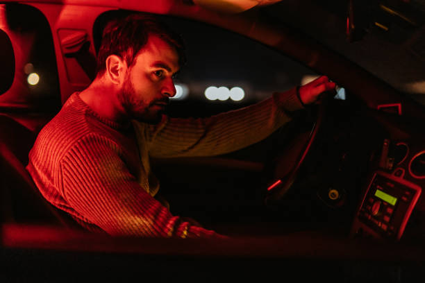 istock Young Man Driving His Car At Night 1445170439