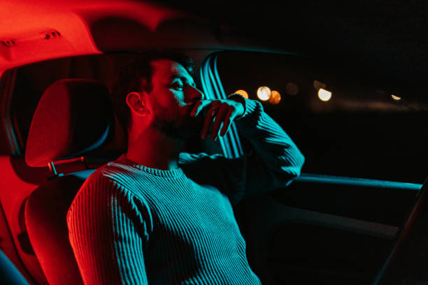 istock Young Man Waiting In His Car At Night 1445170986