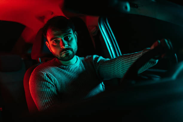 istock Young Man In The Car At Night 1445171006