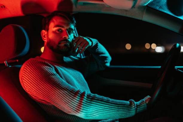istock Young Man In The Car At Night 1445171025