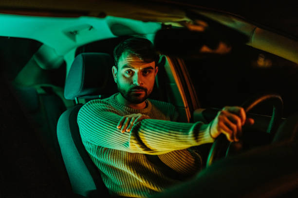 istock Young Man In The Car At Night 1445171602