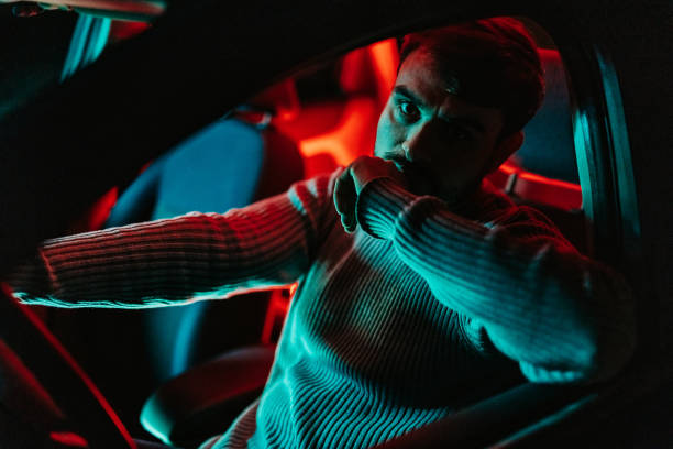istock Young Man In The Car At Night 1445171622