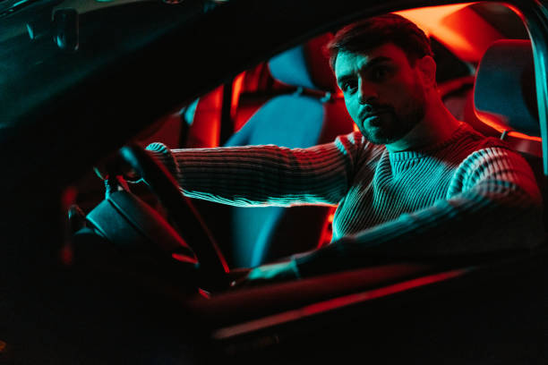 istock Young Man In The Car At Night 1445171657
