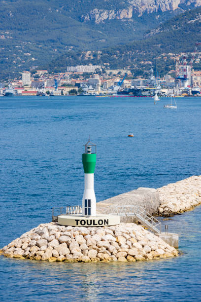 beacon of light on the shore of the port of Toulon stock photo