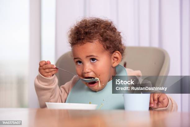 Baby Girl Eating From A Plate Stock Photo - Download Image Now - Spoon, Baby - Human Age, Toddler