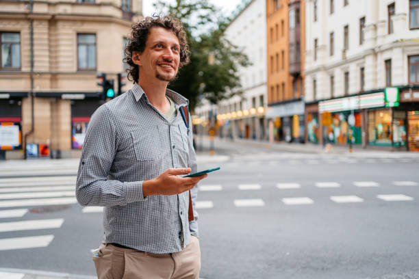 istock Young Man Using Phone On The Street In Stockholm 1445175461
