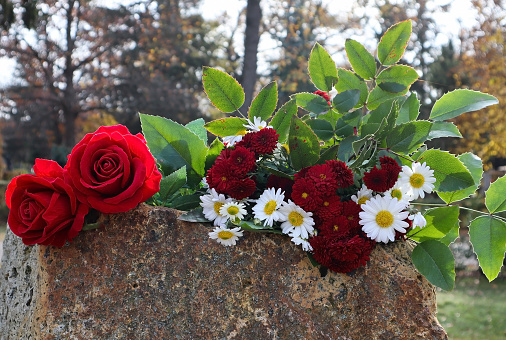 Flowers on the tombstone in the public cemetery