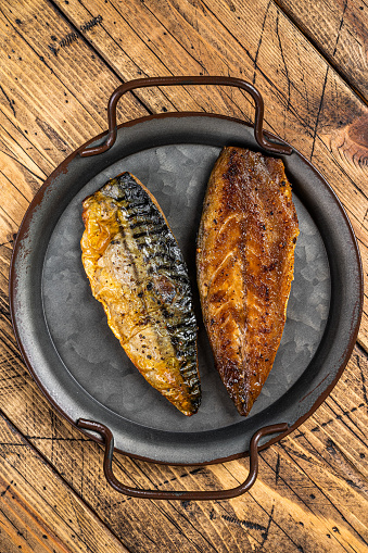 Baked Grilled mackerel fillets. Wooden background. Top view.