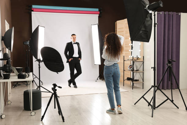 istock Handsome model posing for professional photographer in studio 1445179426