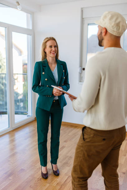 istock Real estate agent and young man talking 1445179550