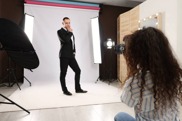 istock Handsome model posing for professional photographer in studio 1445179738