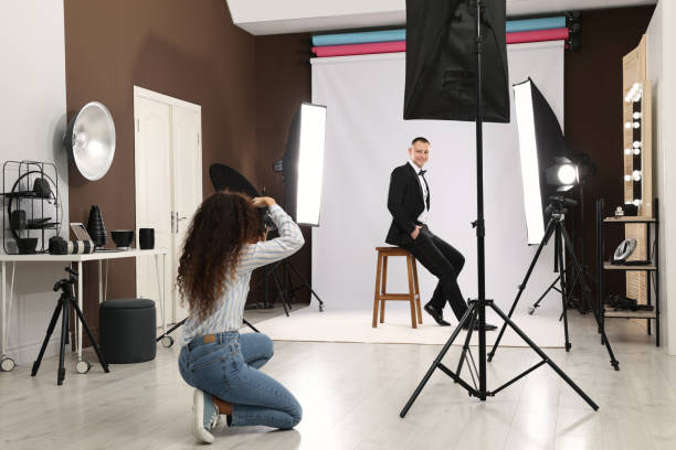 istock Handsome model posing for professional photographer in studio 1445179739