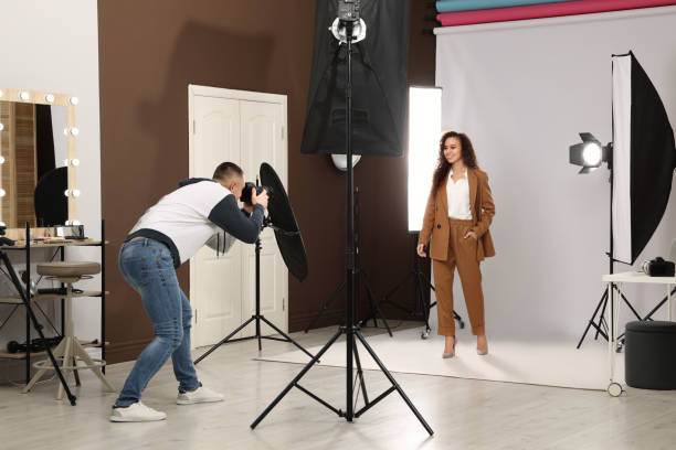 istock Beautiful African American model posing for professional photographer in studio 1445179907