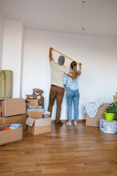 istock Couple using tape measure on their new apartment 1445179992