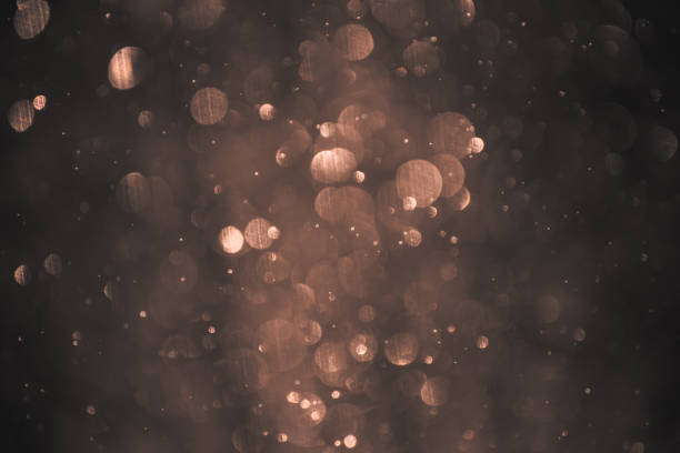 istock Blurred snowflaks in golden light. Colorful glowing bokeh abstract background. 1445180938