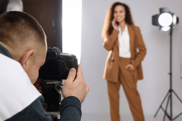 istock Beautiful African American model posing for professional photographer in studio, focus on camera 1445181579