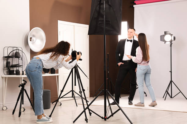 istock Professional photographer and makeup artist with model in studio 1445181994