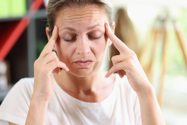 istock Distressed tired woman touch temples, suffer huge migraine 1445182035