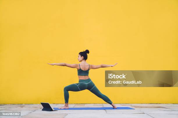 Fit Woman Practicing Yoga With Tablet Outside Stock Photo - Download Image Now - Yoga, Warrior - Person, One Person