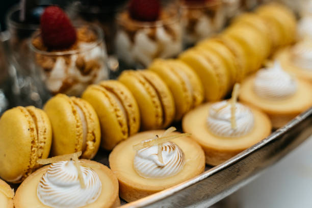 elegant dessert buffet with lemon tarts, macarons and panna cotta