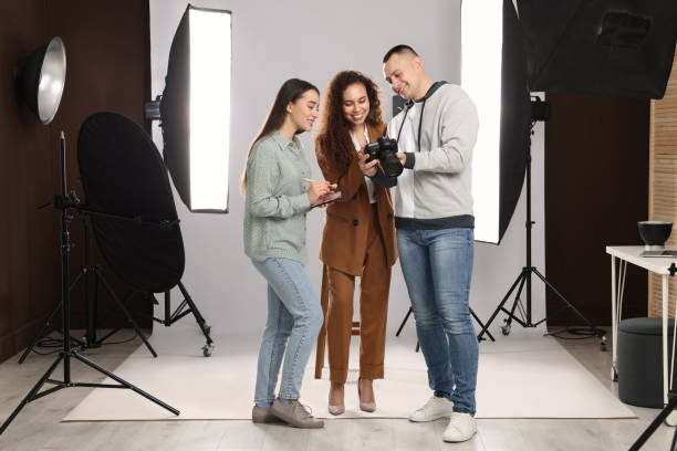 istock Professional photographer and makeup artist with model in studio 1445183778