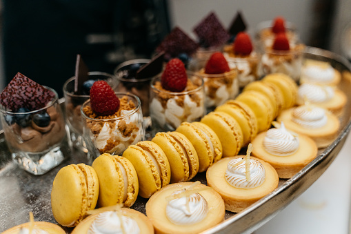 elegant dessert buffet with chocolate mousse, tarts, macarons and panna cotta