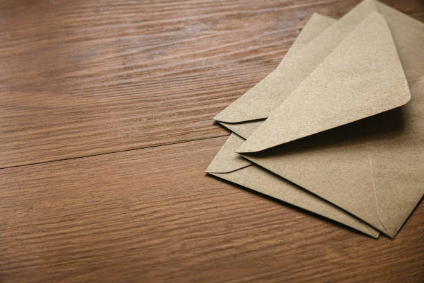 istock Brown craft envelope on a wooden background. 1445188974