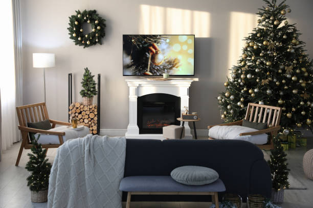 istock Modern TV set on light wall in room decorated for Christmas 1445190268