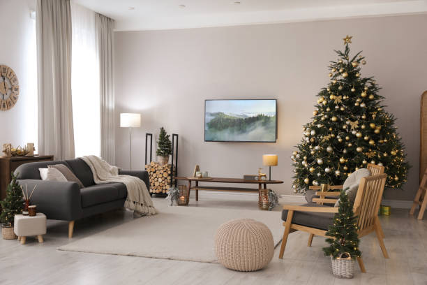 istock Modern TV set on light wall in room decorated for Christmas 1445190648