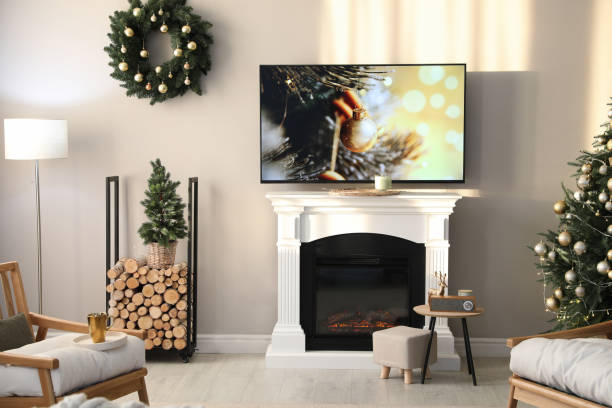 istock Modern TV set on light wall in room decorated for Christmas 1445191596