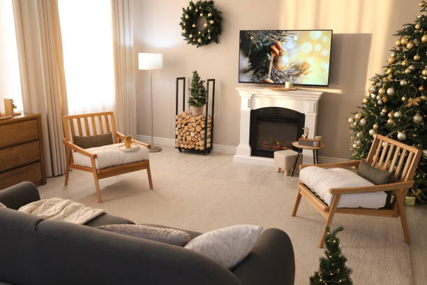 istock Modern TV set on light wall in room decorated for Christmas 1445191641