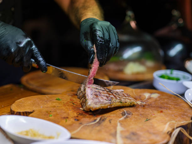 istock a chef in the kitchen cutting a steak 1445191851