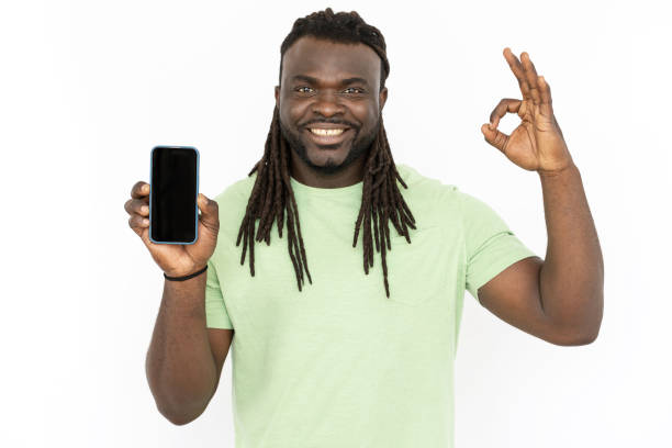 istock Happy man showing phone with empty screen and OK sign 1445192104