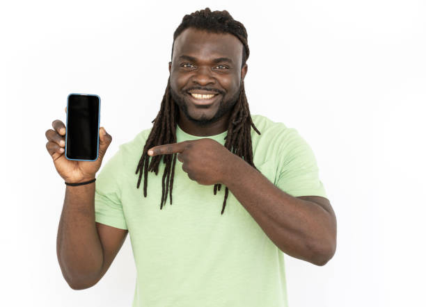 istock Smiling African American man pointing at mobile phone screen 1445192130