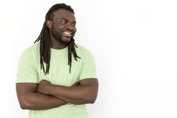 istock Smiling man standing with folded arms and looking at copyspace 1445192138