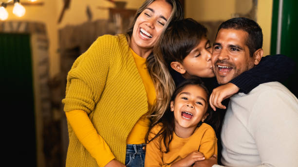 Happy Hispanic family having fun together stock photo