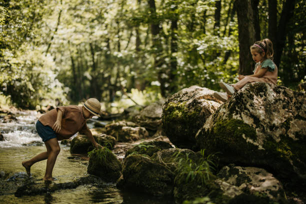 istock Kids having fun by the river 1445192988