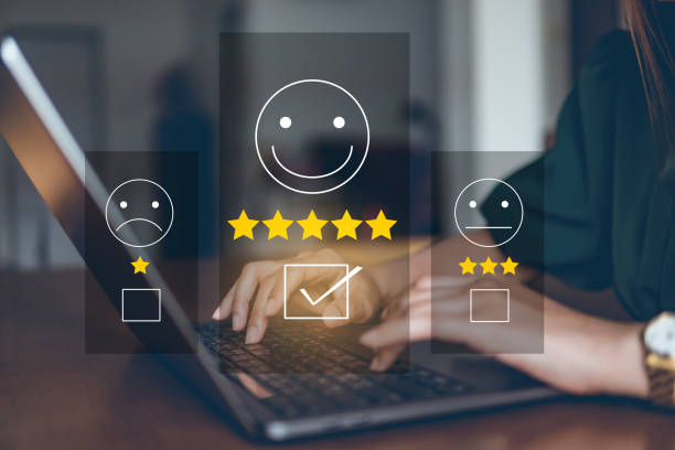 Customer review good rating concept, hand holding smile face and five star on visual screen for positive customer feedback testimonial and testimony.