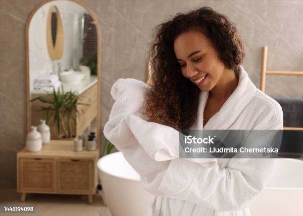 Beautiful African American Woman Drying Hair With Towel In Bathroom Stock Photo - Download Image Now