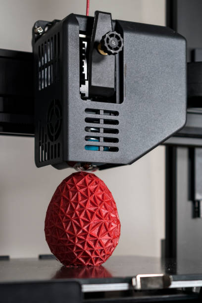 istock Close up of a 3d printer printing a red polygonal egg 1445194685