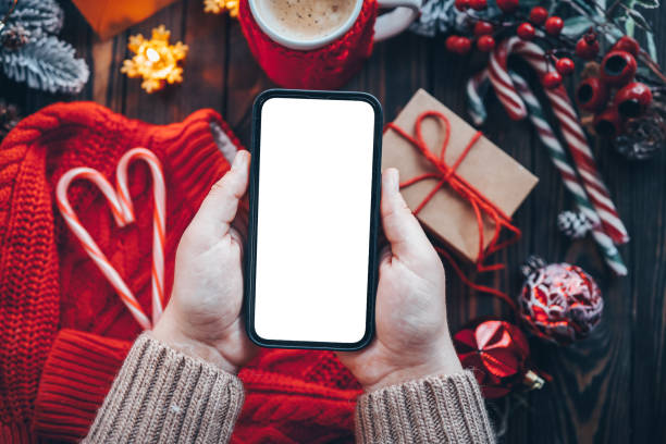 istock Phone in hands with isolated place for text in Christmas atmosphere 1445194957