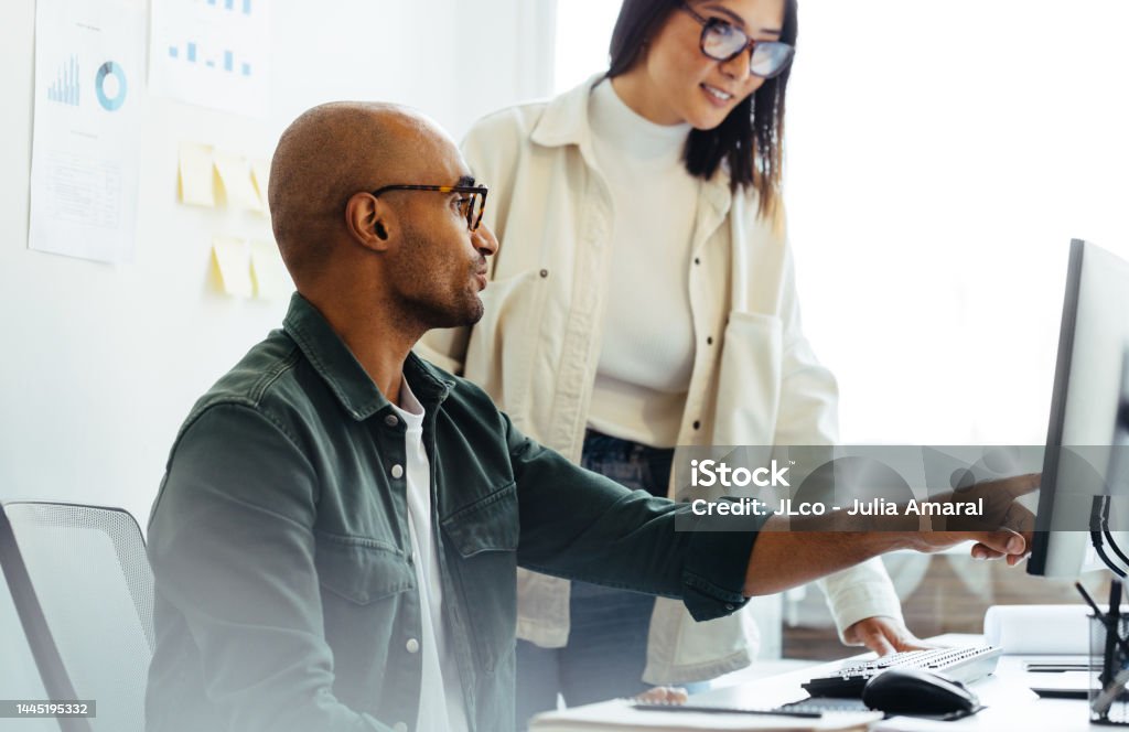 Software Developer Using A Computer And Having A Discussion With His ...