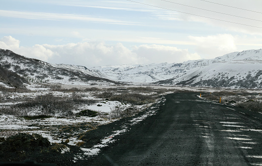 Winding snow asphalt road in Iceland landscape by winter