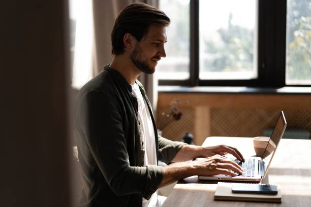 istock Male remote working from home and having work confrence video call. Freelancer working on laptop at home office. 1445197216