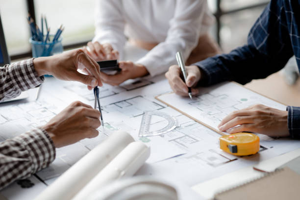 istock Architects and engineers are working together to edit the draft house plan that was designed after it was presented to the client and partially revised the design. Interior design and decoration ideas 1445198061