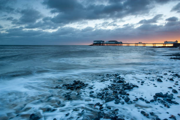 Cromer beach and Victorian pier in Norfolk at sunrise, Great Britain